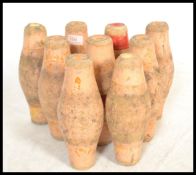 A set of nine vintage early 20th century wooden pub bowling pins / skittles, remnants of original