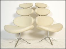 A pair of 20th century modernist designer chrome and leather effect pebble swivel chairs / armchairs