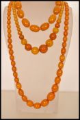 A group of three vintage butterscotch amber bakelite bead necklaces, longest measures approx 30