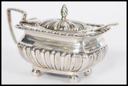 A 19th century Victorian silver hallmarked mustard pot condiment salt raised on bun feet with reeded