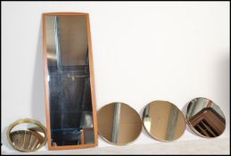 A collection of five retro 20th Century wall mirrors to include three matching circular wall