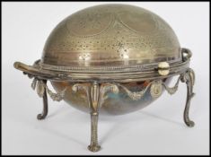 A late Victorian 19th Century silver plate muffin warmer raised on four legs with scrolled feet,