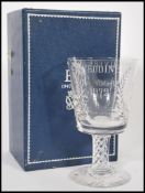 A cased Stuart Crystal QE2 Silver Wedding cut glass large goblet raised on circular foot with air