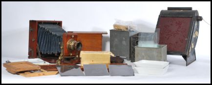 A selection of photography items dating from the early 20th century to include a bellows camera by