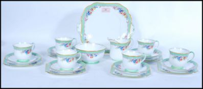 A vintage Aynsley English Fine Bone China six person tea service having floral decoration. Reg No