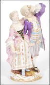 A 19th century Meissen porcelain figurine group of a gallant and companion raised on scrolled