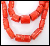 Two vintage large coral bead necklaces having graduating baroque coral beads with silver plated