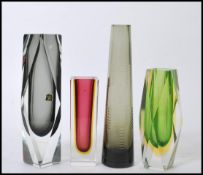 A group of vintage studio art glass to include a group of three tall square vases and a
