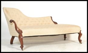 A 19th century Victorian rosewood chaise longue - sofa day bed. The show wood scrolled frame with