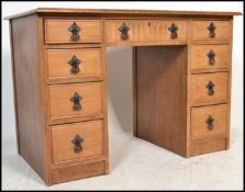 An antique Georgian style oak twin pedestal office desk in the manner of Old Charm / Jaycee. The