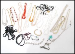A selection of vintage costume jewellery to include rhinestone necklaces and bracelets, an art
