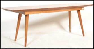 A mid century retro teak wood ' surfboard ' style coffee - occasional table. Raised on turned and