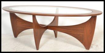 A retro teak wood atomic ' Astro ' oval coffee table by G Plan, having a drop centre glass panel,