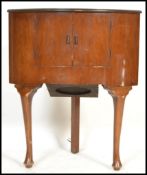 A vintage mid 20th Century circa 1950's Marconi radio receiver, set in a walnut bow fronted corner