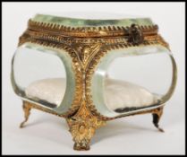 A 19th century French bronze casket trinket box having multiple bevelled glass panels raised on