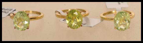 Three 925 silver vermeil ladies rings set with a large oval cut green stones in prong settings. A