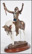 A cold painted figure, ' Deliverance ' by Chuck Ren, copyrighted to underside 1993 for Hamilton