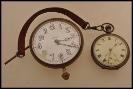 A large vintage 20th century Goliath pocket watch car clock along with another pocket watch on