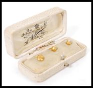 A set of two 18ct gold collar stud buttons complete in fitted case along with a rolled gold