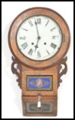 A 20th century inlaid drop dial wall clock, oak cased with a round face having roman numerals to the