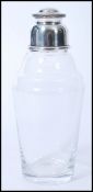 A vintage 20th century silver plated lidded glass cocktail shaker. The conical tapered body with