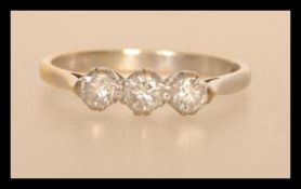 A hallmarked 18ct gold ring set with three brilliant cut diamonds total approx 35 pts. Size N.5.