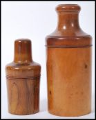 Two early 20th Century turned olive wood bottle casings with screw lids concealing bottles to the