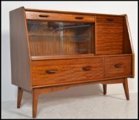 A vintage / retro 20th Century teak wood highboard / credenza / sideboard, having an arrangement