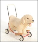 A vintage retro Mulholland & Bailie puppy push toy, the Labrador style puppy raised on a tubular