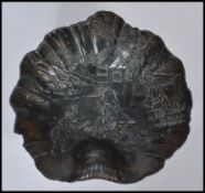 An early 20th century Japanese bronze / bronzed spelter bowl of scalloped form having relief