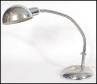 A vintage retro 20th century anglepoise type desk lamp raised on a circular base with adjustable