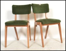 A pair of mid century retro blond wood dining chairs in the manner of Gordon Russell, Broadway. Each