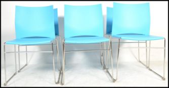 A set of six contemporary stacking dining chairs, moulded seat pads and back rests in one section,