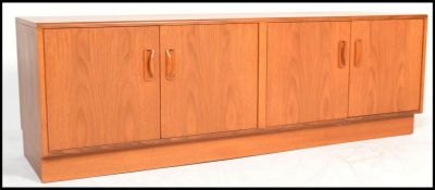 A retro 20th century G - Plan Fresco teak wood low sideboard having an arrangement of cupboards