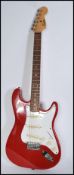 A vintage retro 20th century Encore stratocaster type electric guitar. The shaped red body having