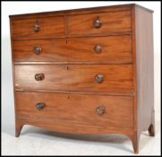 A George III 19th century mahogany chest of drawers being raised on kick legs with 2 short over 3