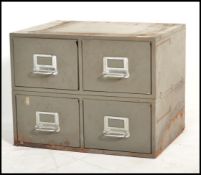 A 1920's Industrial metal 4 drawer filing cabinet having 4 drawers with pull handles and in the