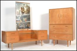 A vintage mid 20th Century light oak tallboy, two long doors over two drawers raised on shaped