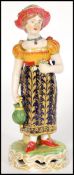 A late 18th / early 19th century Derby figurine of a lady flower picker with basket having a deep