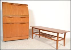 A 1970's Danish influence teak wood bureau together with a teak coffee table of rectangular form
