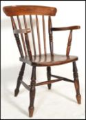 A 19th Century Victorian Windsor spindle back elbow armchair  / chair in beech and elm, raised on