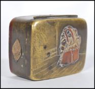 A 19th century Japanese bronze and brass snuff / pill pot box having bronzed decoration of a large