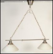 A pair of contemporary twin snooker table ceiling lights having two conical glass shades with chrome