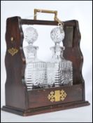 An early 20th century oak Tantalus having brass mounts and lock escutcheons with brass handle. Top