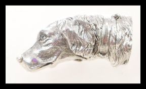 A silver vesta case in the form of a dogs head, having a hinged opening. Weight 42.2g.