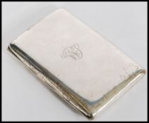 A large early 20th century silver hallmarked cigarette case of plain rectangular form having gilt