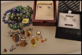 A selection of ladies jewellery to include a pair of stamped 18k gold stud earrings prong set with