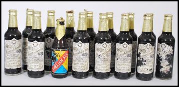 A group of 14 bottles of vintage Samuel Smith's Imperial Stout with paper labels and one bottle of