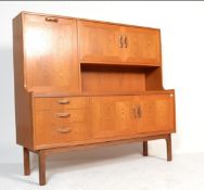 A 20th century vintage retro Sienna G-Plan highboard teak sideboard, raised on four turned legs,
