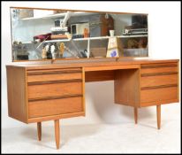 A vintage retro 20th Century teak wood kneehole dressing table, central recess flanked by two